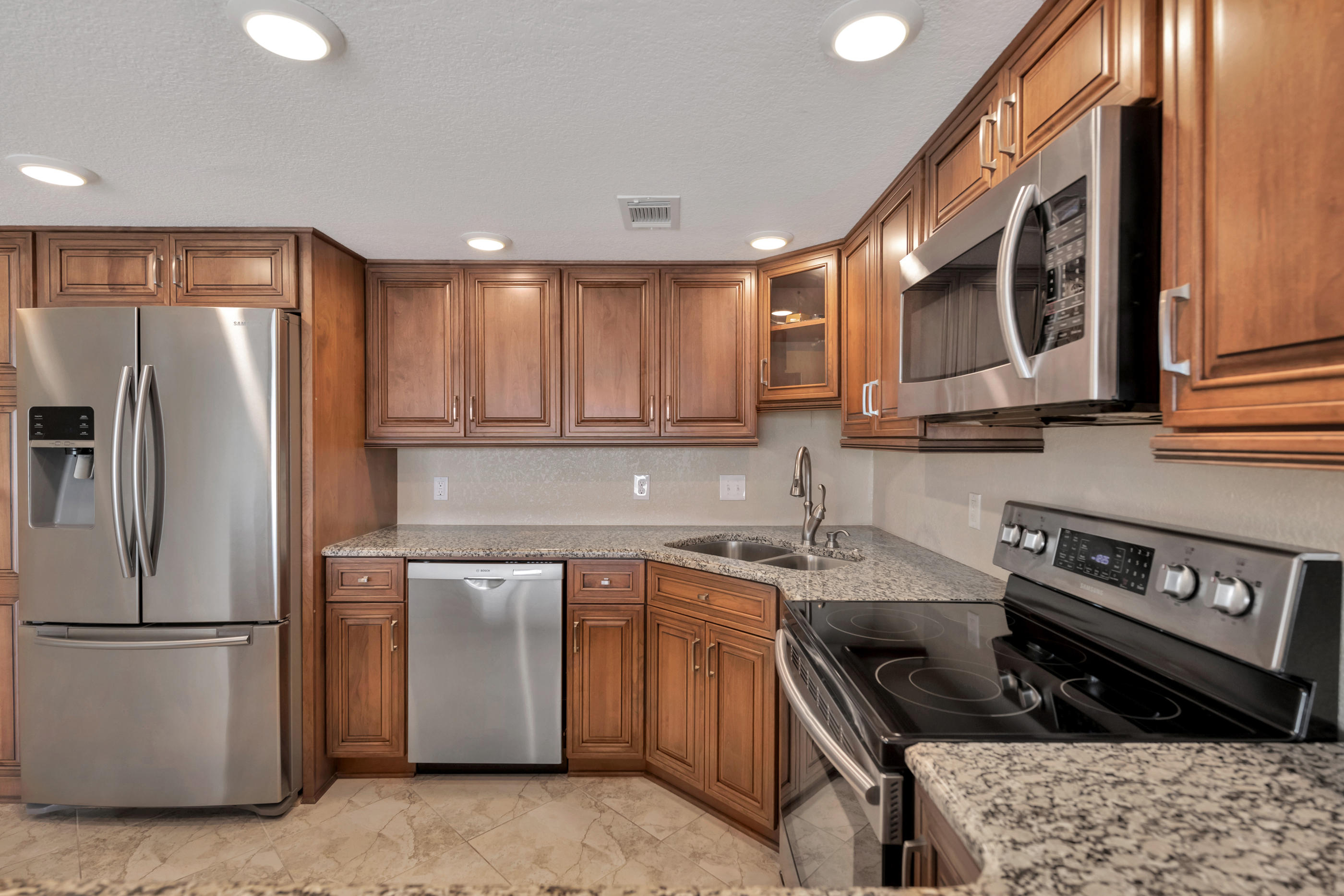 151 Calhoun Avenue, Unit 409 Destin, FL 32541 - Photo 2 of 15 a kitchen with a sink stove and refrigerator
