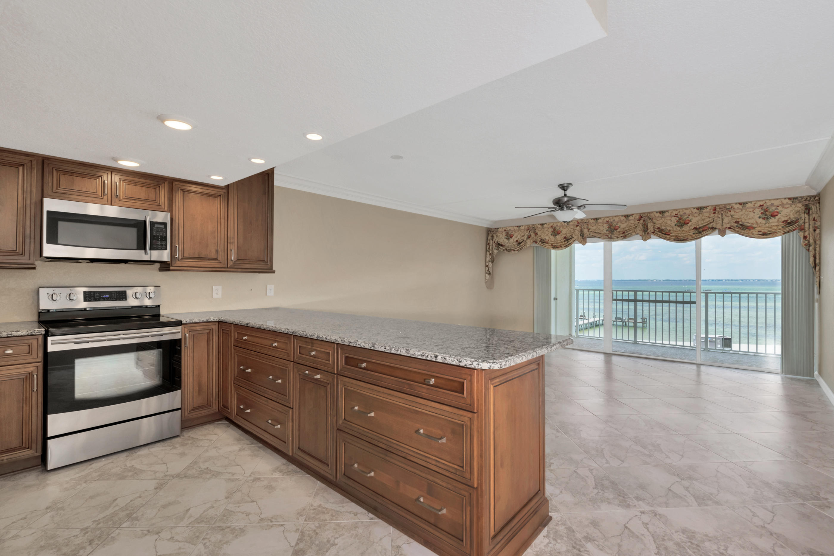 151 Calhoun Avenue, Unit 409 Destin, FL 32541 - Photo 5 of 15 a kitchen with granite countertop a stove and a sink