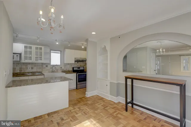 a large kitchen with kitchen island a sink stainless steel appliances and cabinets