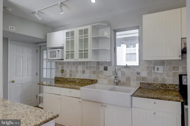 a kitchen with a sink and cabinets