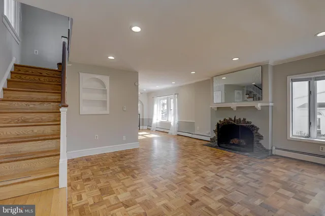 a view of empty room with a fireplace and window