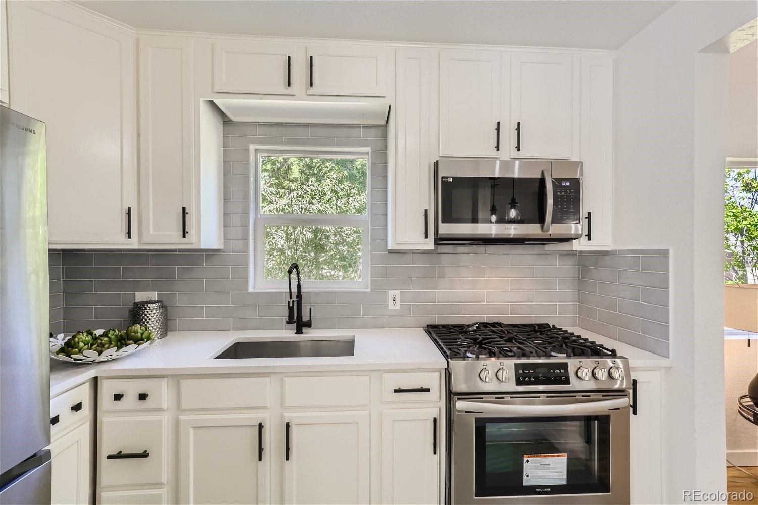 3090 Pierce Street Wheat Ridge, CO 80214 - Photo 13 of 28 a kitchen with a stove and a microwave