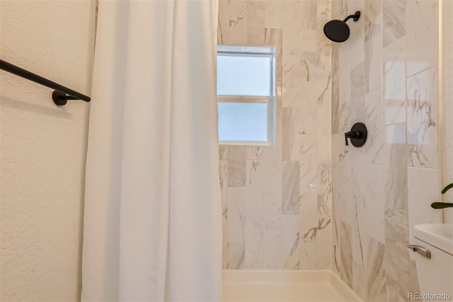 3090 Pierce Street Wheat Ridge, CO 80214 - Photo 15 of 28 a bathroom with a shower