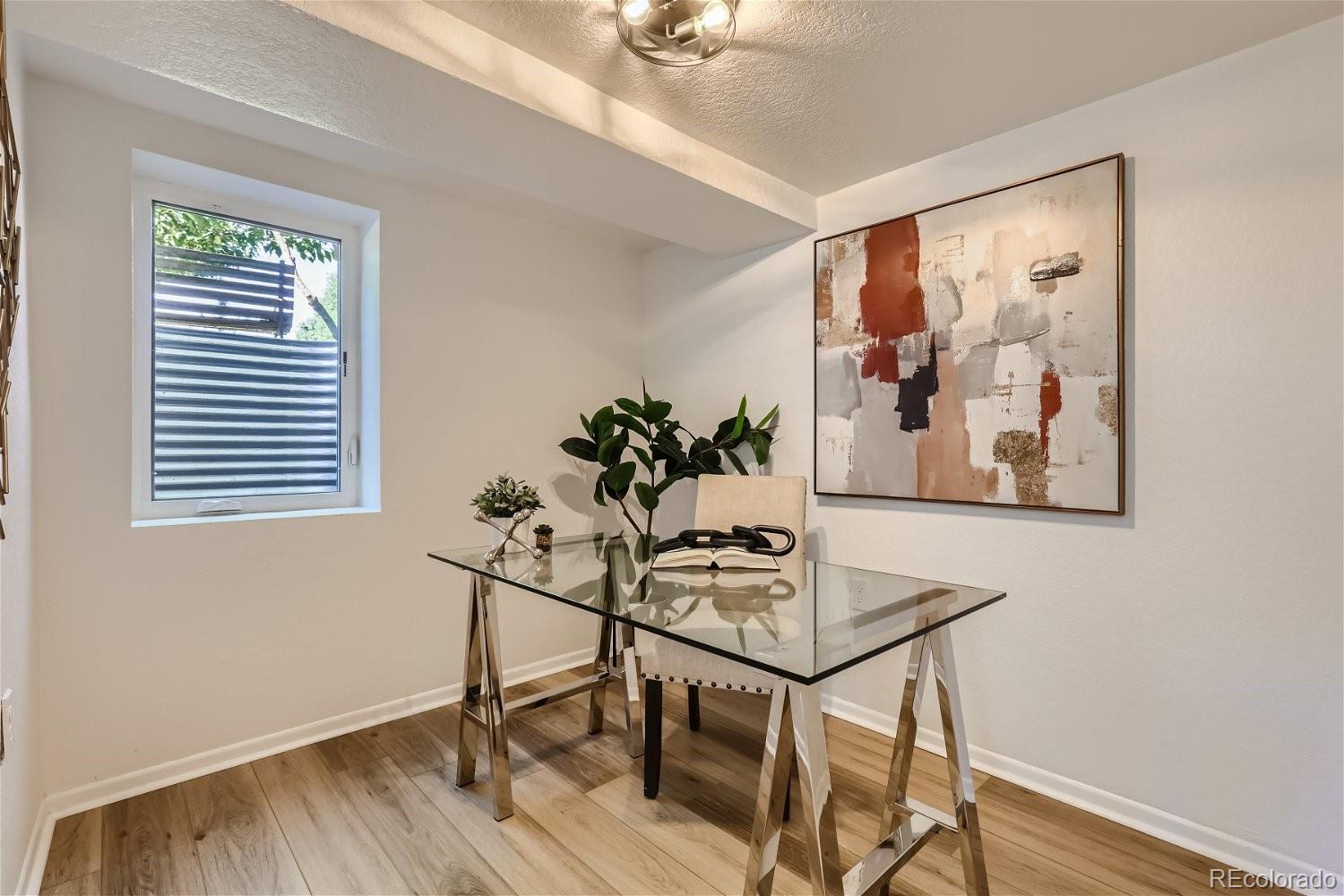 3090 Pierce Street Wheat Ridge, CO 80214 - Photo 19 of 28 a view of a workspace with furniture and a window