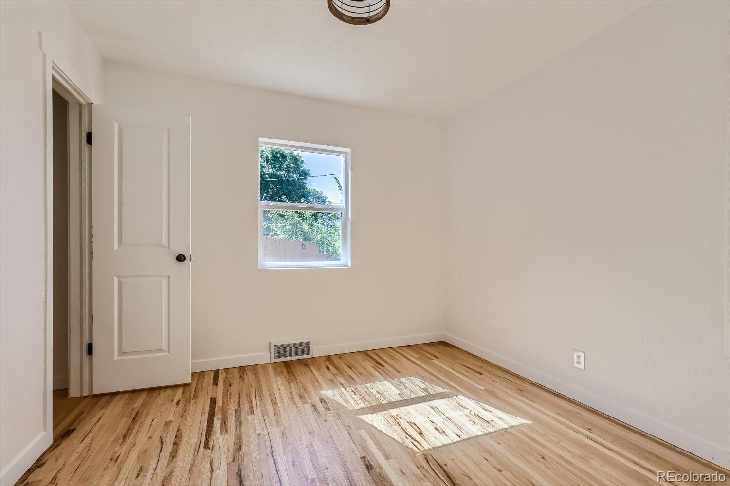 3090 Pierce Street Wheat Ridge, CO 80214 - Photo 20 of 28 a view of empty room with wooden floor and fan