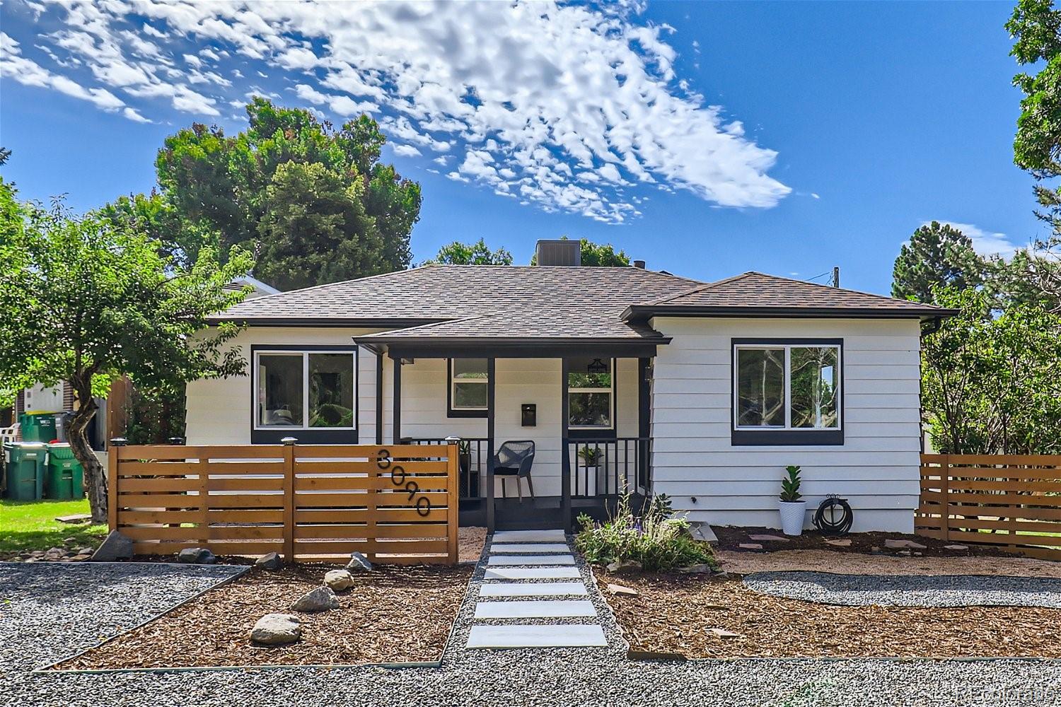 3090 Pierce Street Wheat Ridge, CO 80214 - Photo 2 of 28 a front view of a house with garden