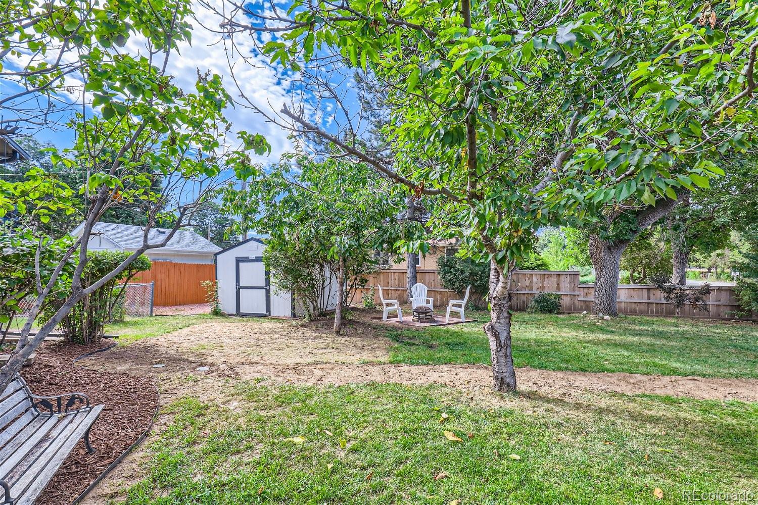3090 Pierce Street Wheat Ridge, CO 80214 - Photo 23 of 28 a front view of a house with a yard and tree