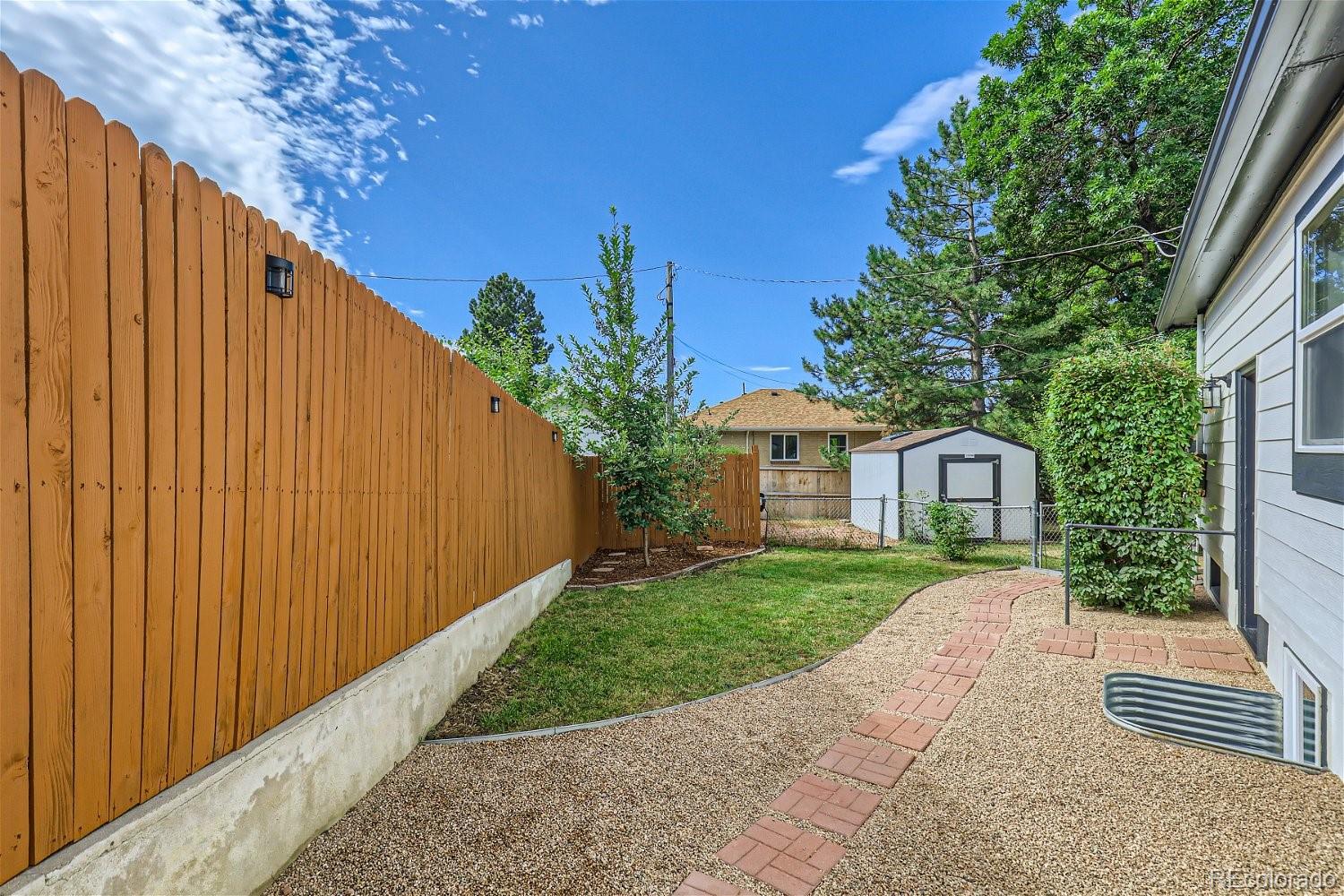 3090 Pierce Street Wheat Ridge, CO 80214 - Photo 25 of 28 a view of a back yard with a trees