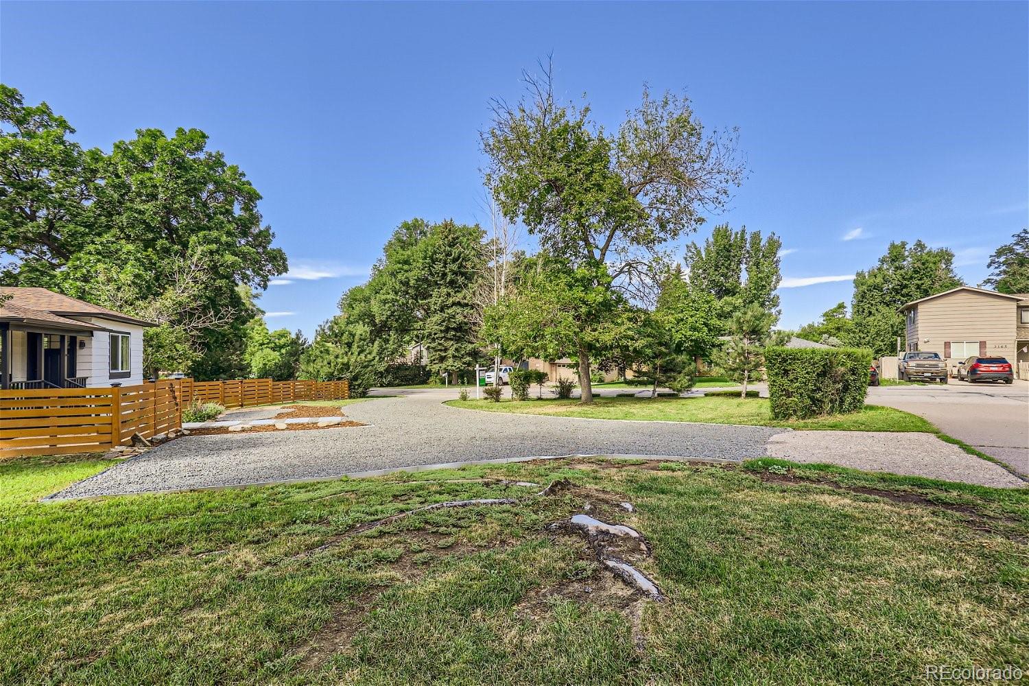 3090 Pierce Street Wheat Ridge, CO 80214 - Photo 26 of 28 a view of a yard with plants and trees