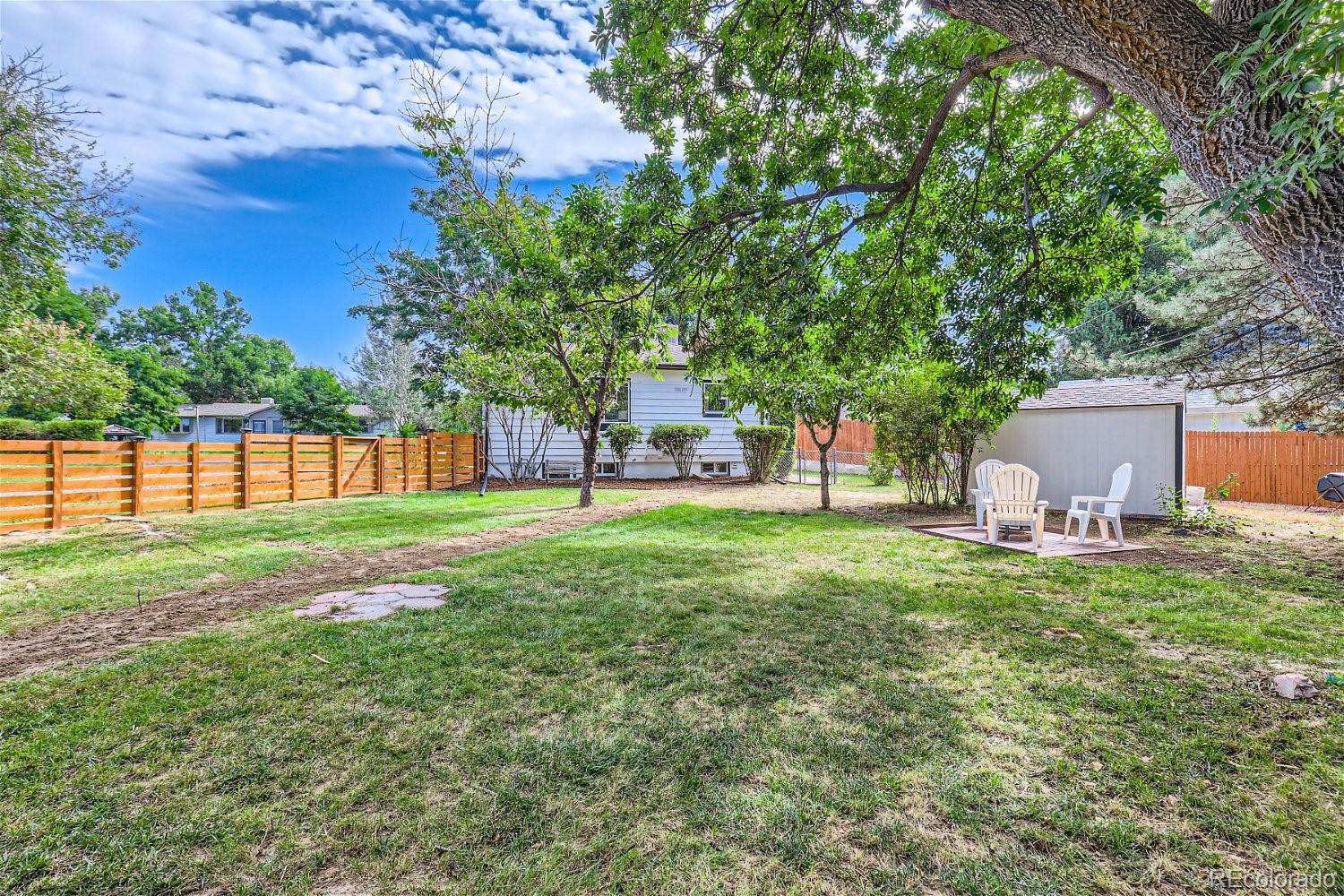 3090 Pierce Street Wheat Ridge, CO 80214 - Photo 27 of 28 a backyard of a house with table and chairs