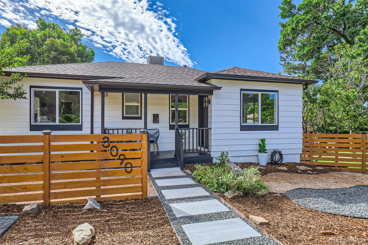3090 Pierce Street Wheat Ridge, CO 80214 - Photo 3 of 28 a front view of a house with a garden