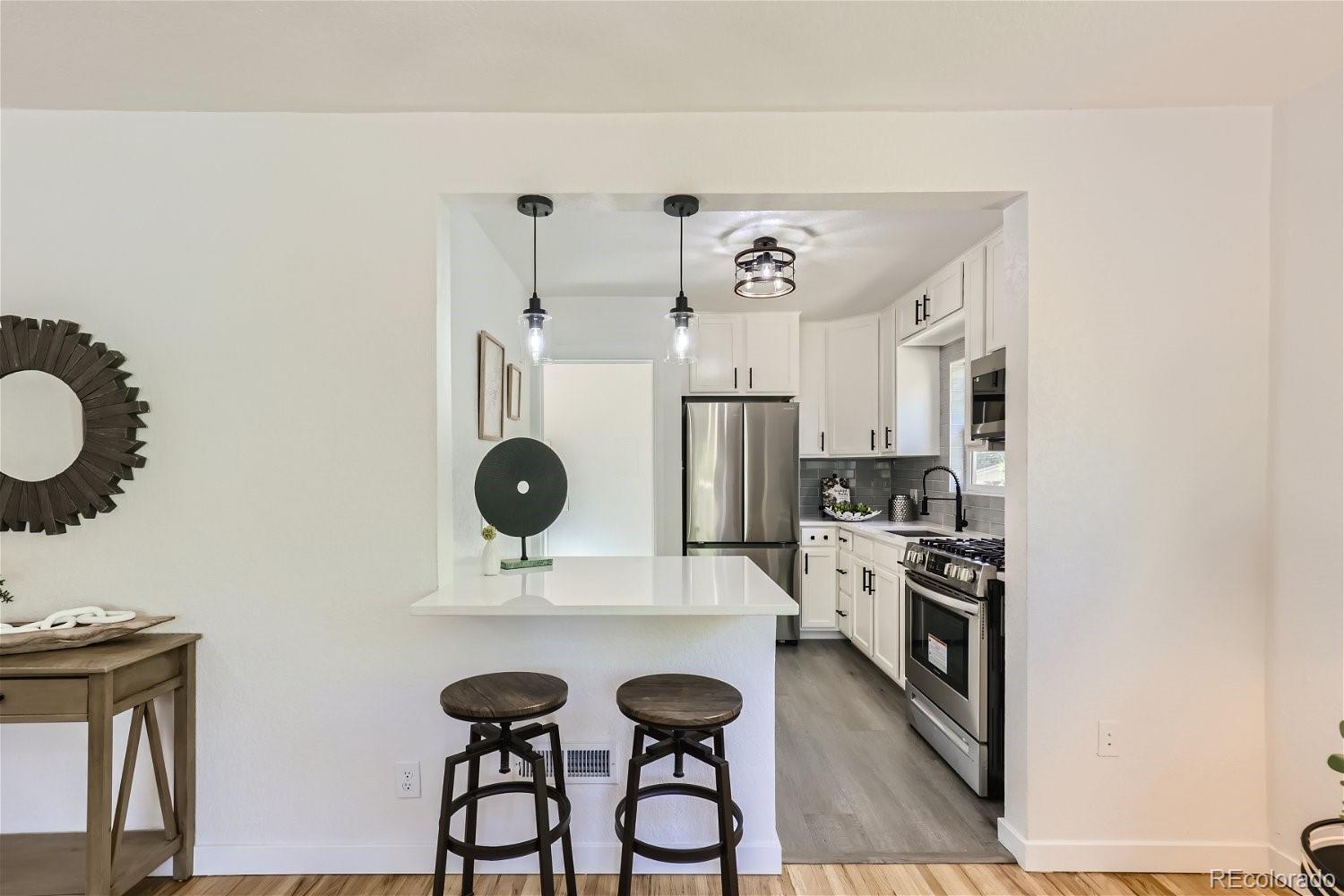 3090 Pierce Street Wheat Ridge, CO 80214 - Photo 4 of 28 a view of kitchen with a sink and a refrigerator