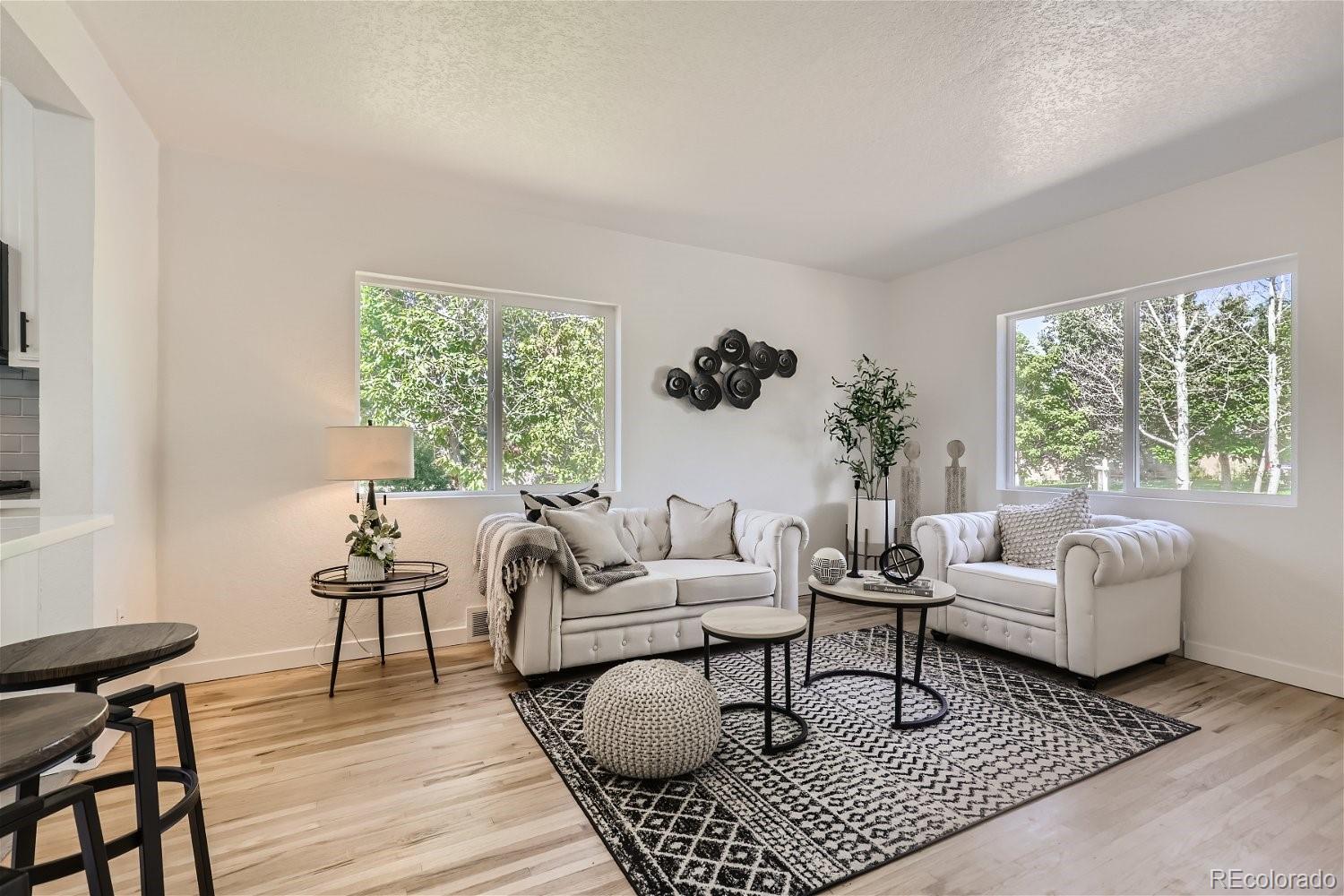 3090 Pierce Street Wheat Ridge, CO 80214 - Photo 6 of 28 a living room with furniture and a large window