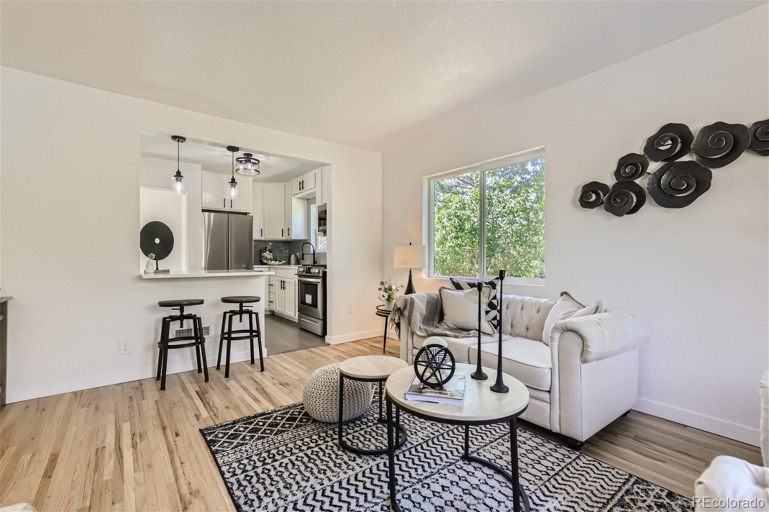 3090 Pierce Street Wheat Ridge, CO 80214 - Photo 7 of 28 a living room with furniture and a table