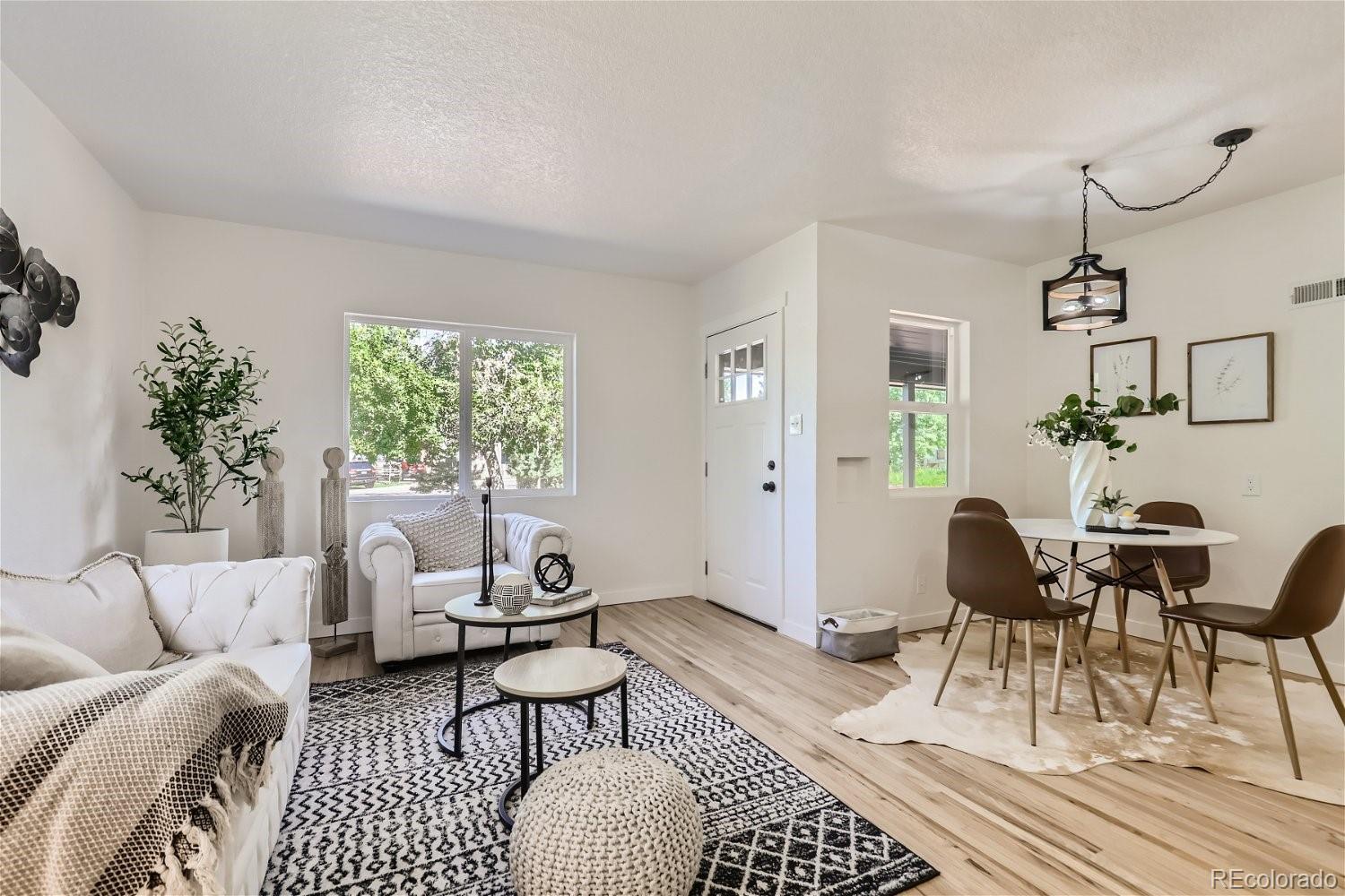 3090 Pierce Street Wheat Ridge, CO 80214 - Photo 9 of 28 a living room with furniture a rug and a window