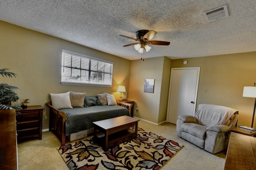 11719 Cedar Form Lane Meadows Place, TX 77477 - Photo 23 of 39 a living room with furniture and a flat screen tv