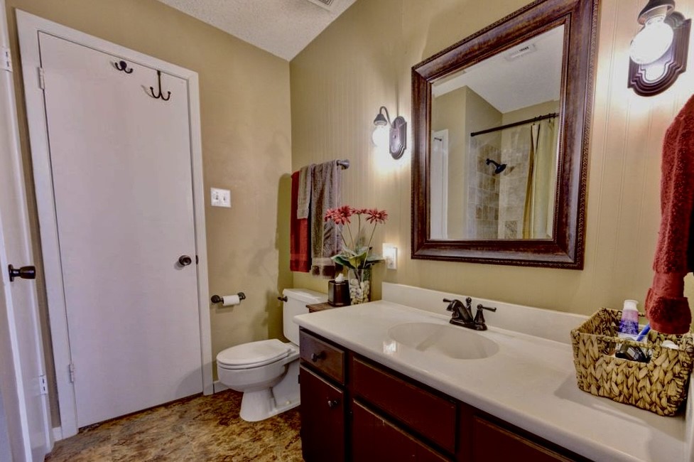 11719 Cedar Form Lane Meadows Place, TX 77477 - Photo 32 of 39 a bathroom with a granite countertop sink toilet and shower