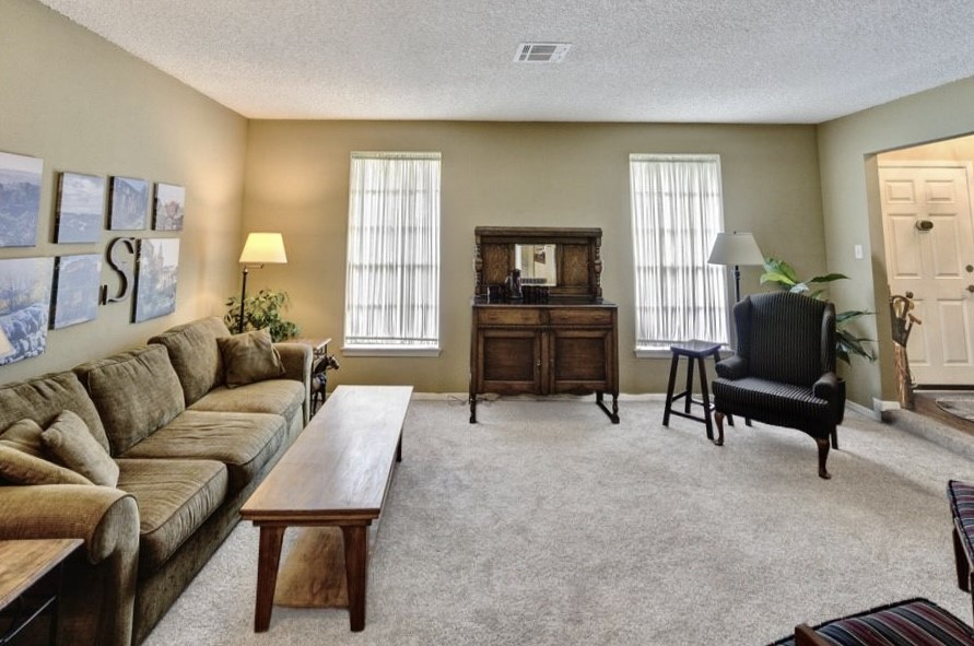 11719 Cedar Form Lane Meadows Place, TX 77477 - Photo 6 of 39 a living room with furniture and a flat screen tv