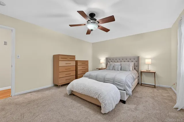 a bedroom with a bed and ceiling fan