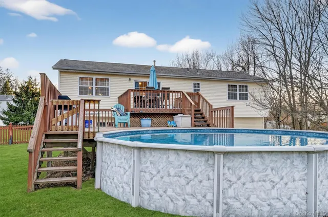 a view of a swimming pool with a yard and a fountain