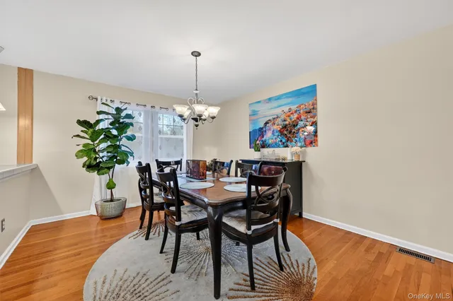 a view of a dining room with furniture wooden floor and a chandelier