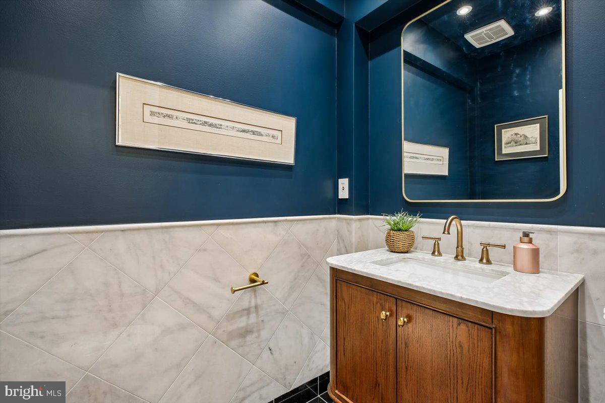 6317 Poe Road Bethesda, MD 20817 - Photo 17 of 43 a bathroom with a sink vanity and a mirror