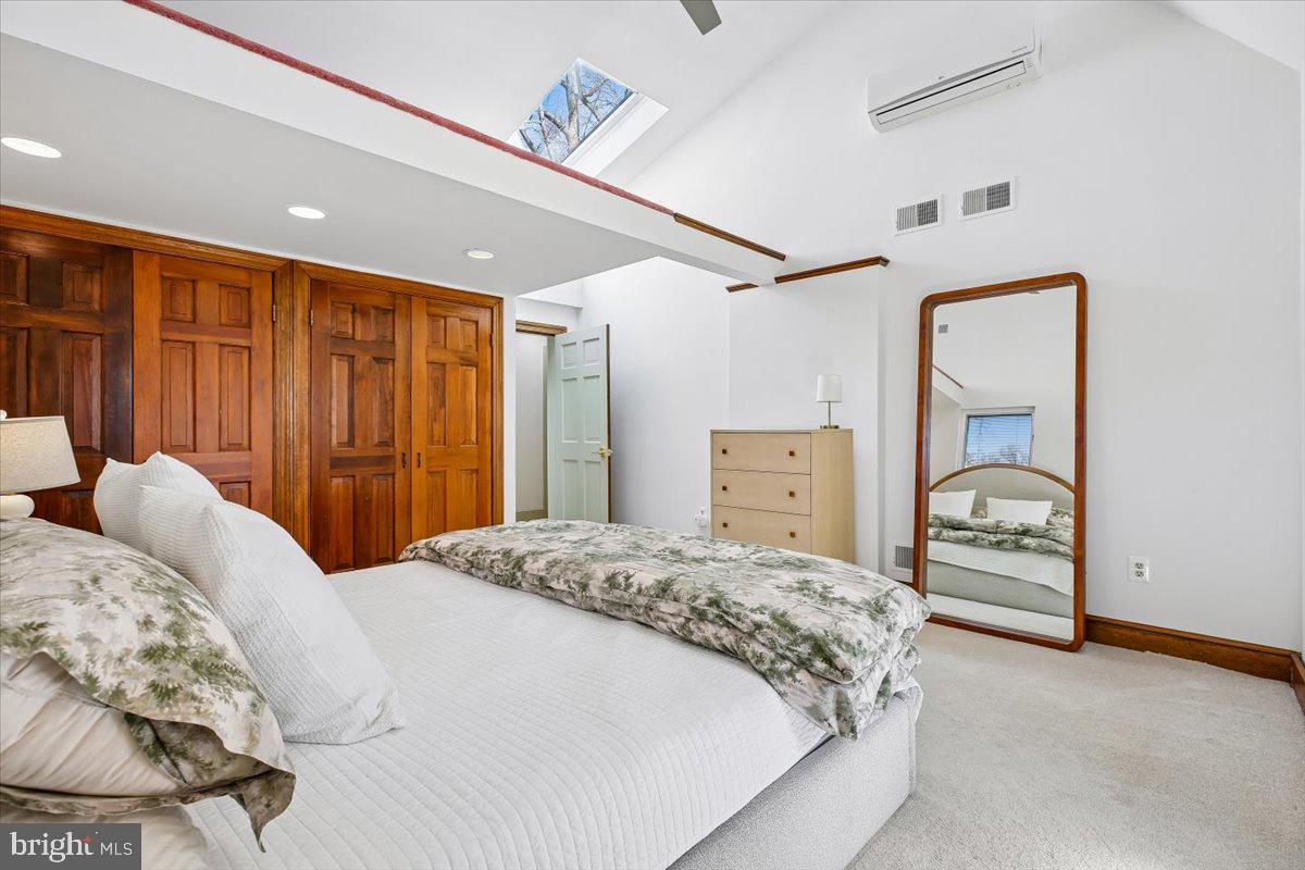 6317 Poe Road Bethesda, MD 20817 - Photo 21 of 43 a bedroom with a large bed and a chandelier