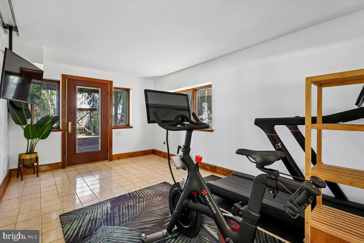 6317 Poe Road Bethesda, MD 20817 - Photo 36 of 43 a view of a livingroom with furniture and a gym cycle