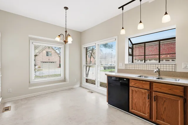 a kitchen with granite countertop a sink stove and cabinets
