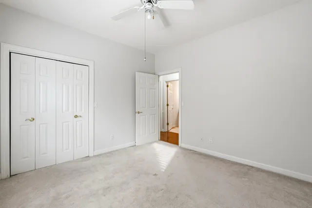 a view of an empty room and a ceiling fan