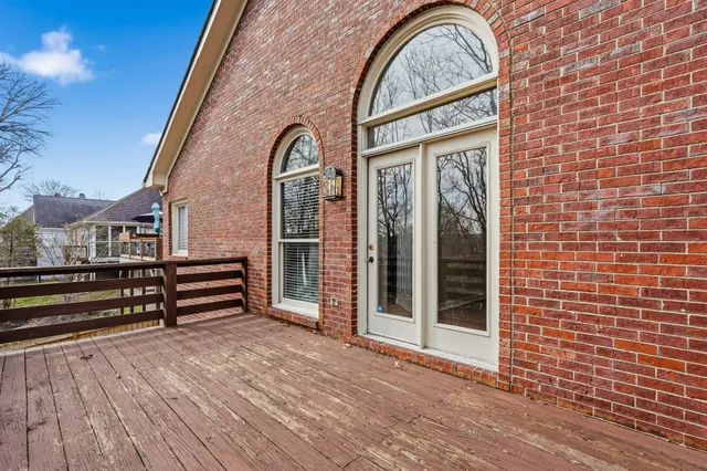 a view of outdoor space with deck and trees