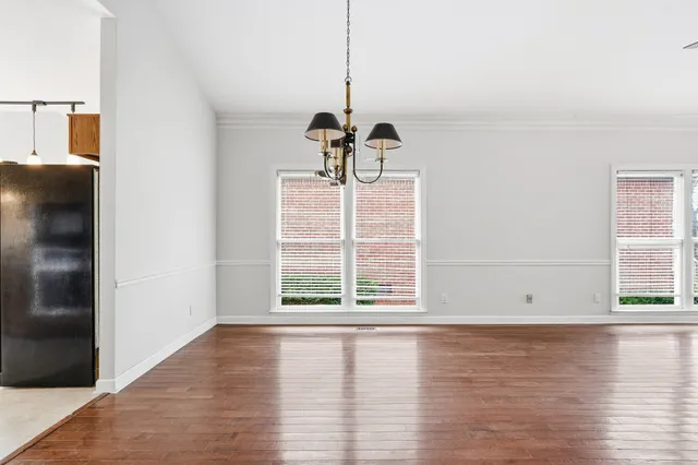 a view of wooden floor and windows in a room
