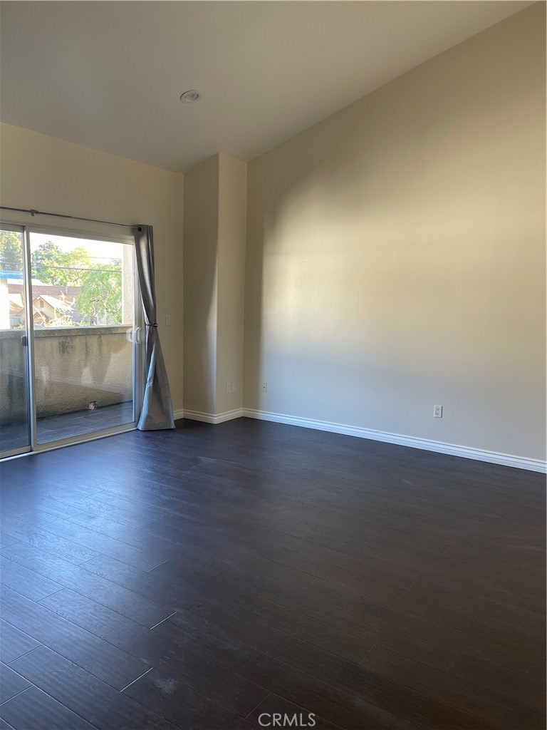 255 North Michigan Avenue Pasadena, CA 91106 - Photo 13 of 18 an empty room with wooden floor and windows