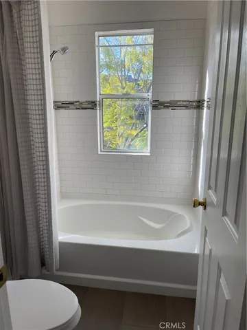 a bathroom with a bathtub and window