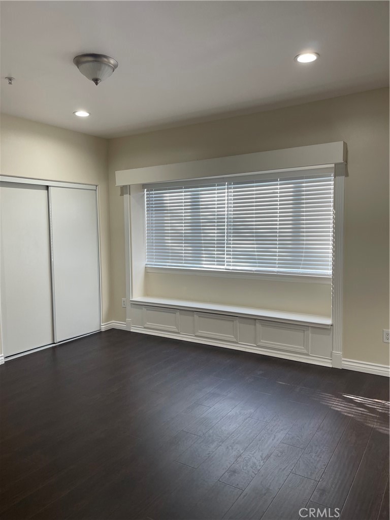 255 North Michigan Avenue Pasadena, CA 91106 - Photo 17 of 18 an empty room with wooden floor and windows