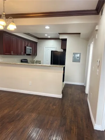 a view of a kitchen with a sink and a refrigerator