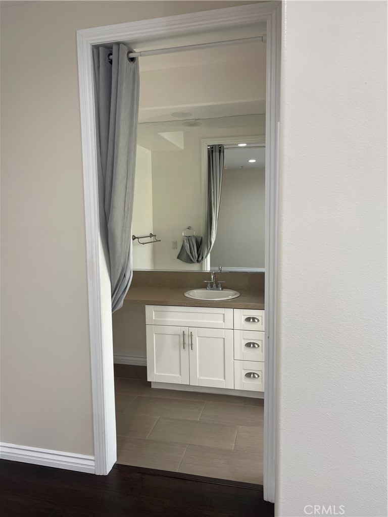255 North Michigan Avenue Pasadena, CA 91106 - Photo 10 of 18 a bathroom with a double vanity sink and mirror