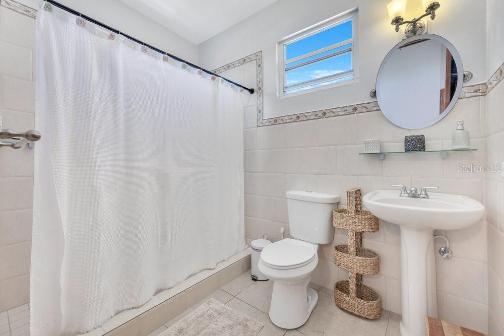 413 Camino Carretas, Unit A7 Rincon, Rincón 00677 - Photo 15 of 23 a bathroom with a sink toilet and shower