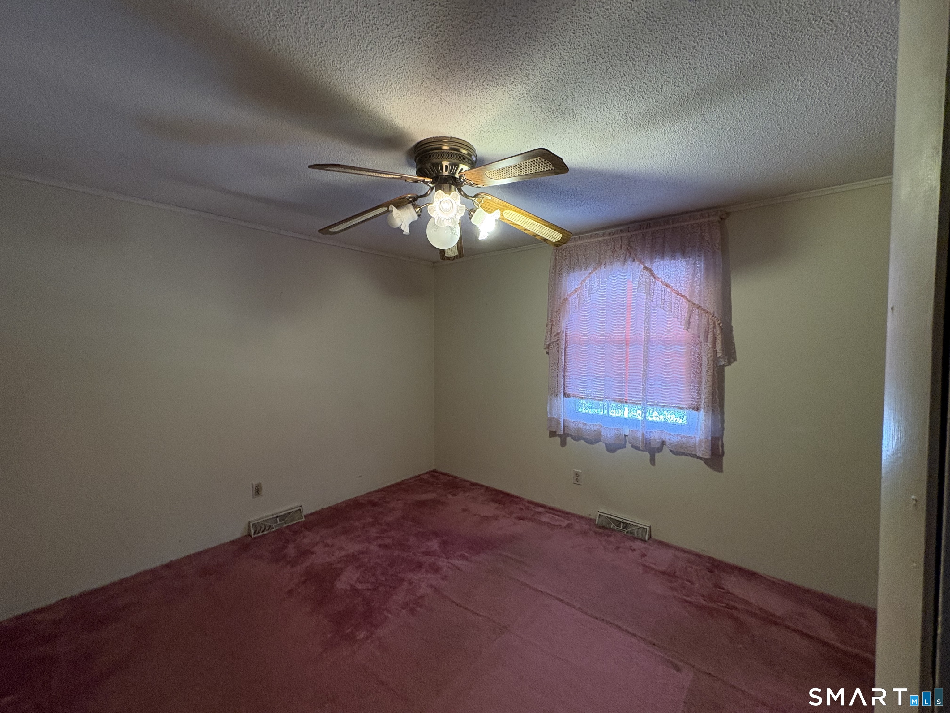 249 Malcolm Road West Haven, CT 06516 - Photo 9 of 17 an empty room with windows and fan