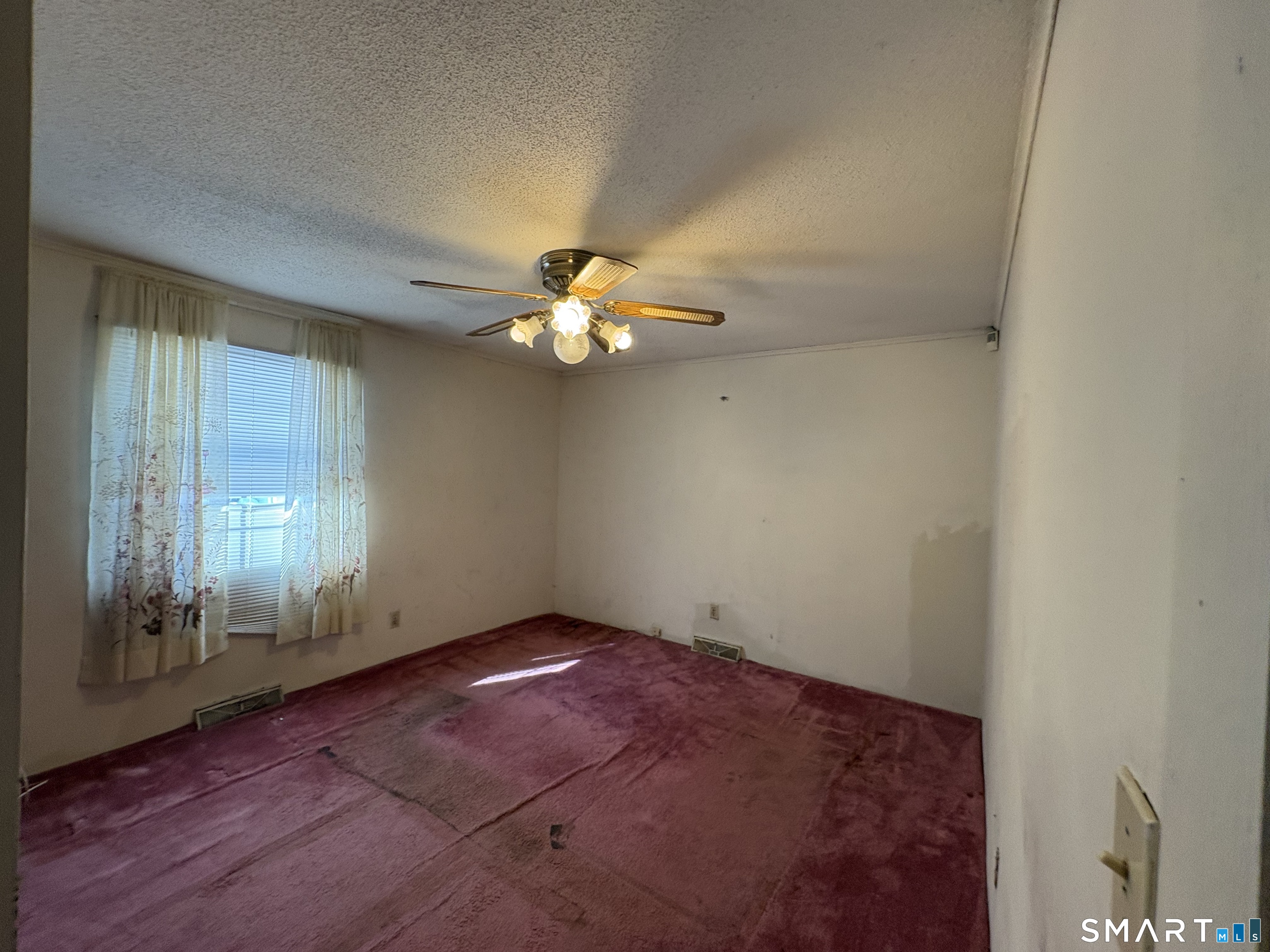 249 Malcolm Road West Haven, CT 06516 - Photo 10 of 17 a view of an empty room with window and wooden floor