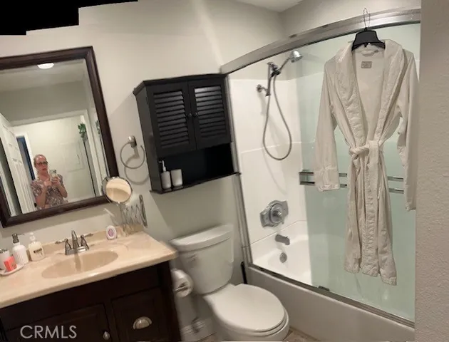 a bathroom with a sink vanity mirror and toilet