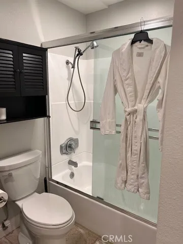 a bathroom with a shower a toilet and a shower