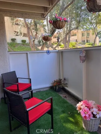 a view of a backyard with plants and outdoor seating