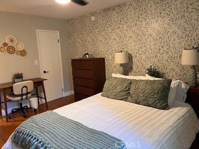 a bedroom with a bed and chair