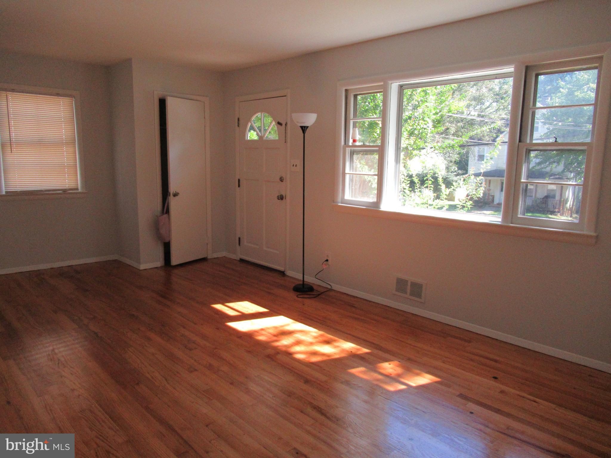 5608 Berwyn Road Berwyn Heights, MD 20740 - Photo 3 of 24 a view of an empty room with wooden floor and a window