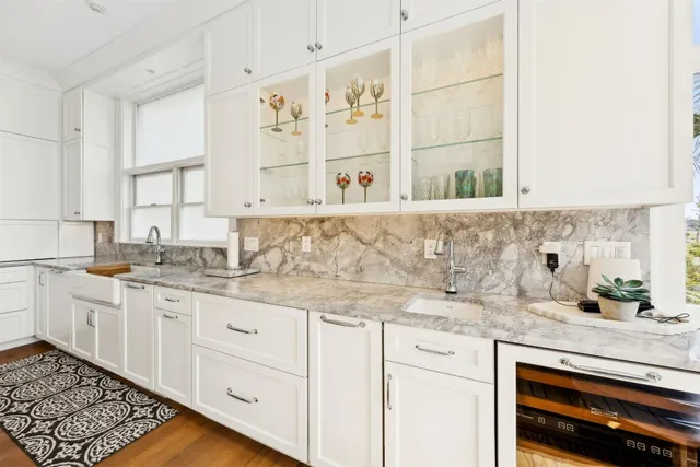a kitchen with a stove and a white wooden cabinets