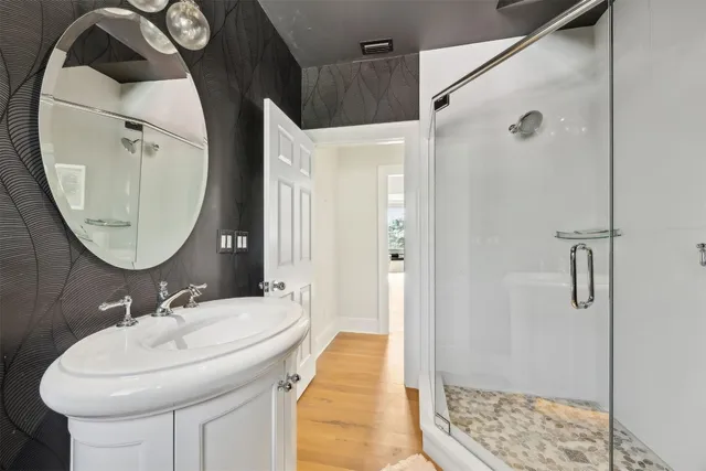 a bathroom with a granite countertop shower mirror and a sink