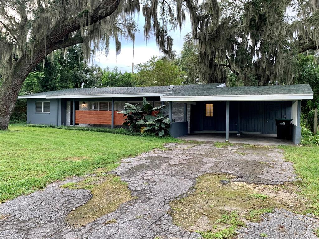 702 Sweetbriar Road Orlando, FL 32806 - Photo 1 of 1 a front view of a house with garden