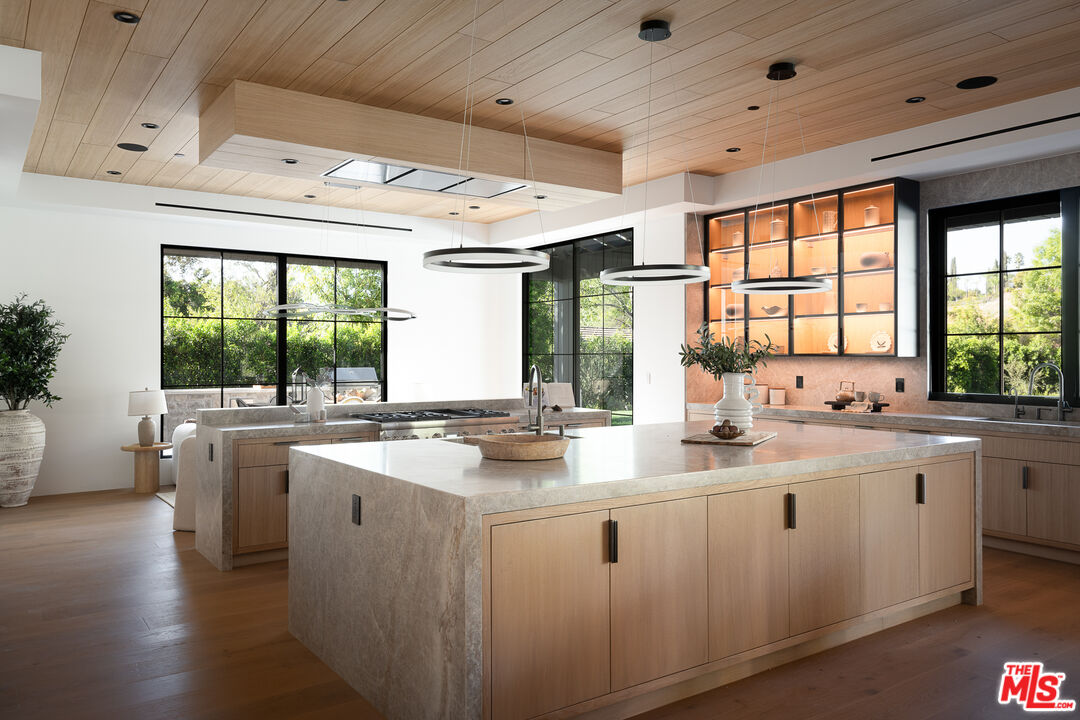 23615 Long Valley Road Hidden Hills, CA 91302 - Photo 28 of 75 a kitchen with sink a window and cabinets
