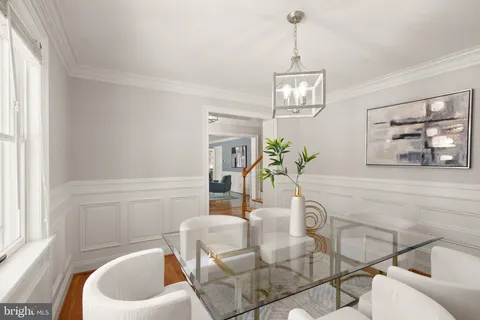 a dining room with furniture and wooden floor